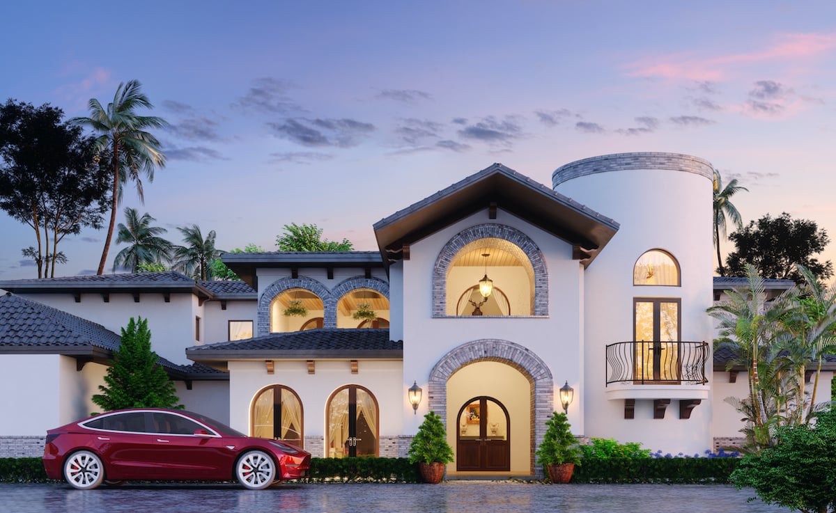 mansion with tesla out front